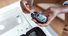 Nurse using blood sugar tester